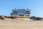 A wall of windows overlook the ocean in this brand new home 